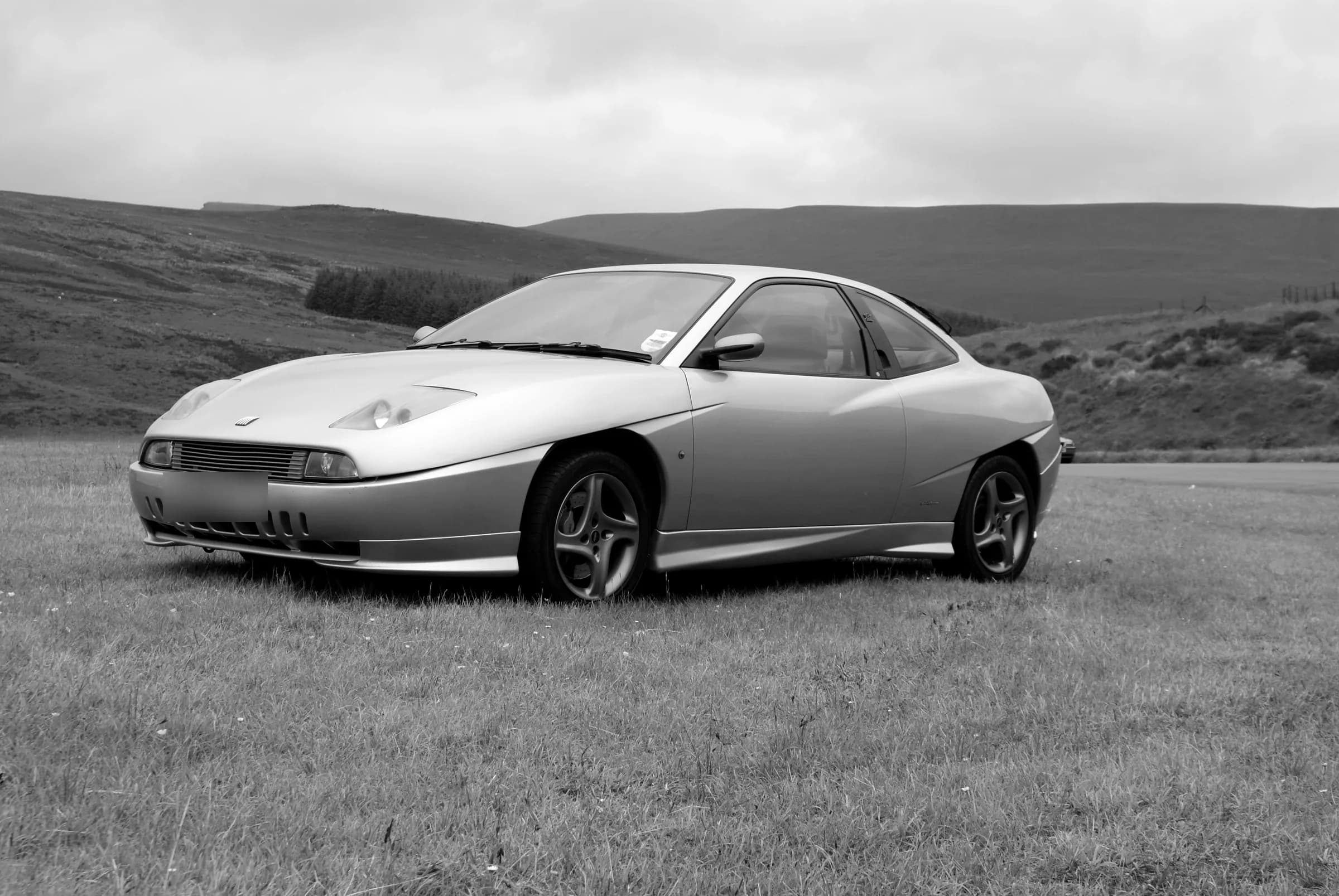 A silver Fiat Coupé on the hillside at Glyn Tarell